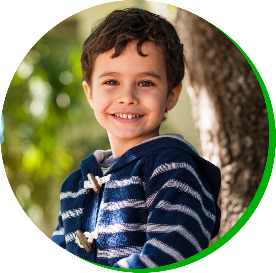 a young boy who is smiling and looking at the camera